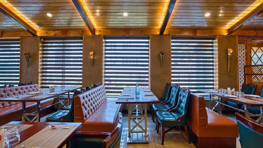 Royal Comfort Regency’s cosy restaurant seating with plush chairs and ambient lighting, perfect for relaxed meals and gatherings.