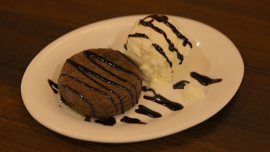 Delicious chocolate dessert with ice cream, beautifully plated and served at Royal Comfort Regency’s in-house restaurant.