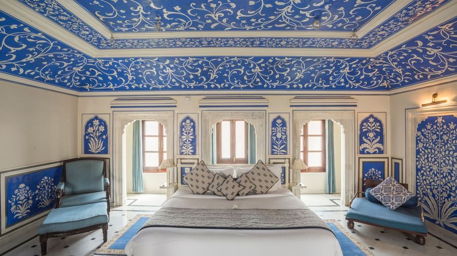 A bedroom at Royal Heritage Haveli featuring a large bed and walls and ceiling adorned with intricate blue and white patterns.