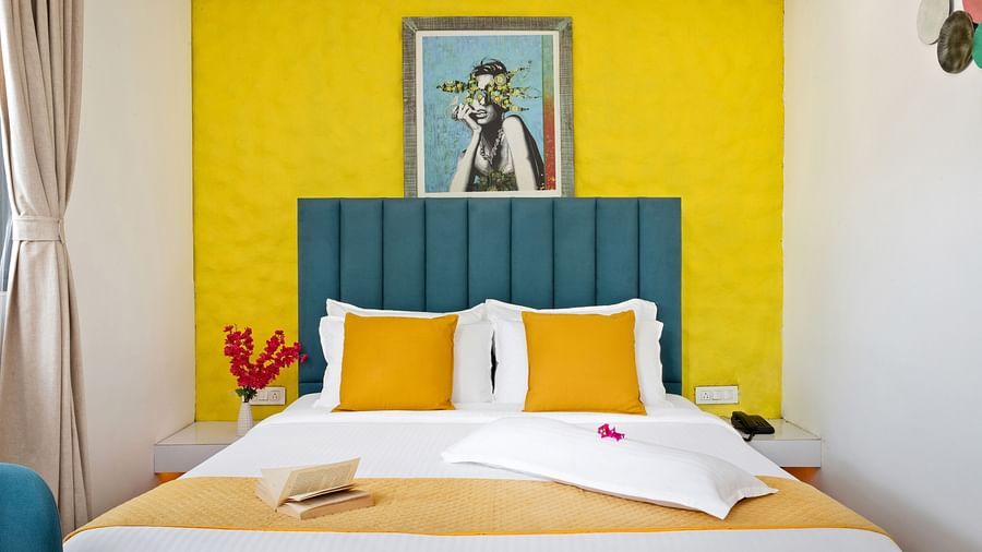 Comfortable bedroom with a bold backdrop, a vibrant headboard, and contemporary decor.