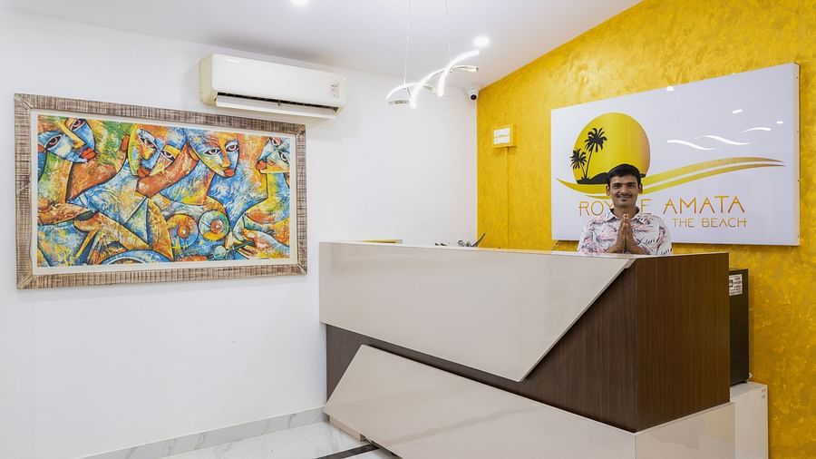 A reception area with a bright feature wall, modern desk, and artistic décor on display.
