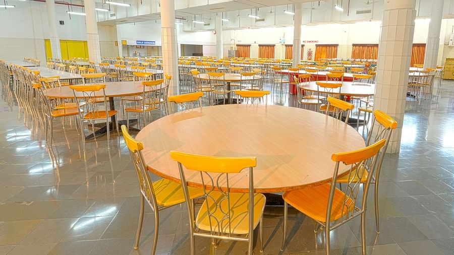 A colourful cafeteria with round tables at Sahara - Cozy Dining in Hyderabad.