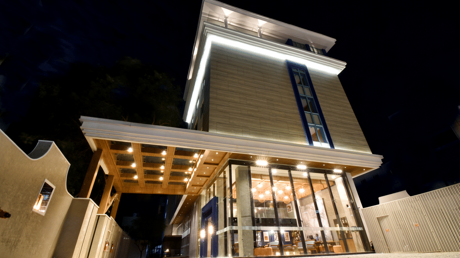 The modern, multi-storey facade of the building beautifully illuminated at night at Sands Point Hotel, Pondicherry.