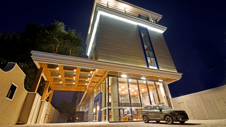 The modern, multi-storey facade of the building beautifully illuminated at night at Sands Point Hotel, Pondicherry.