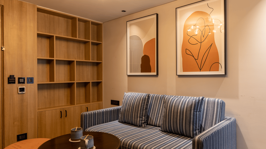 Built-in wooden bookshelves and 2 pieces of floral art at Sands Point Hotel, Pondicherry.