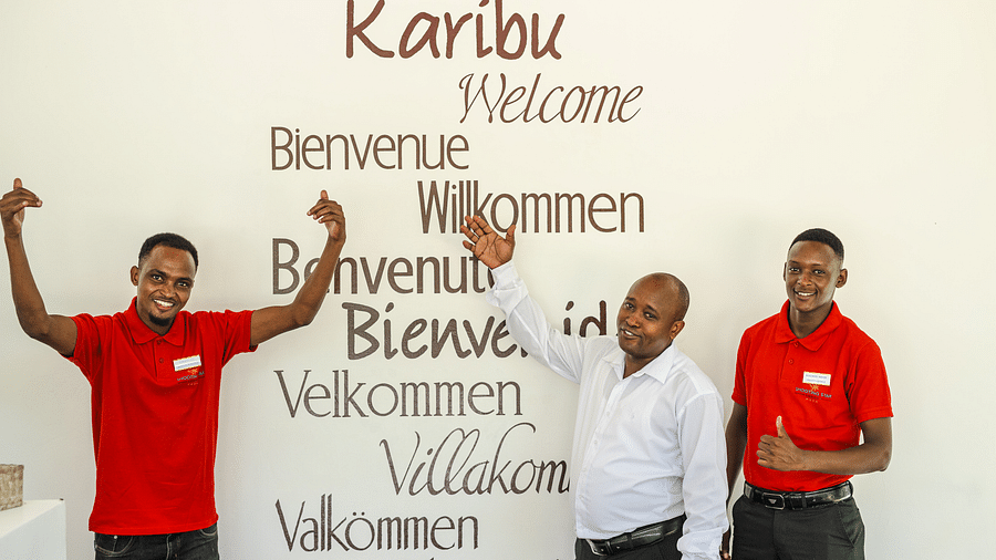View of staff members at shooting star Boutique Hotel showing welcome wall