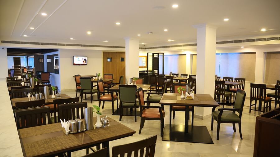 Indulge in classic delight at Padmam Veg Restaurant, with a cosy interior and wooden chairs.