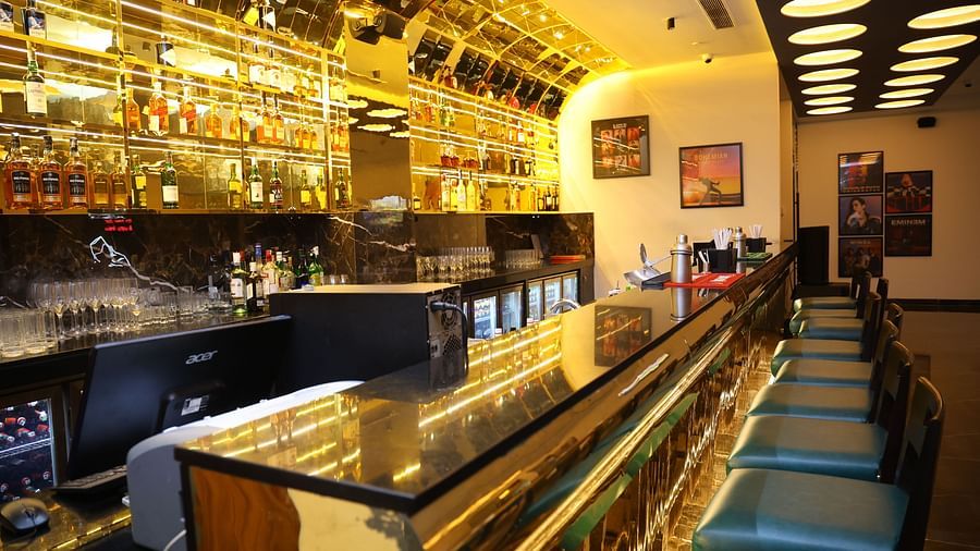 The bar at SRM Hotel Chennai, featuring a vibrant selection of cocktails and mixed drinks.