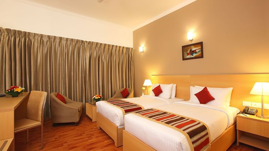 Twin beds inside Premium Room - Starlit Suites, Kochi