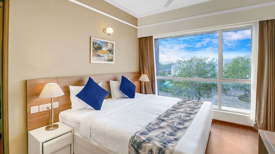 a double bed inside one of the rooms - Starlit Suites Newtown, Kolkata