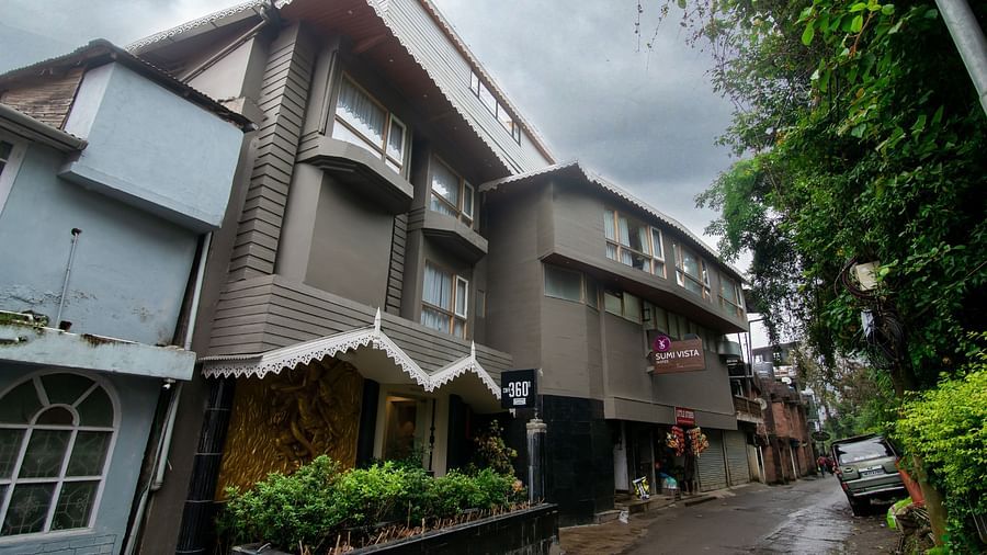 A facade image of Sumitel Vista TV Tower having lush greenery around