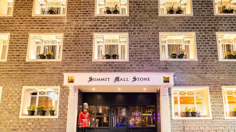Front view of Summit Mall Stone Hotel, Darjeeling, showcasing room corridors with a distinctive block design