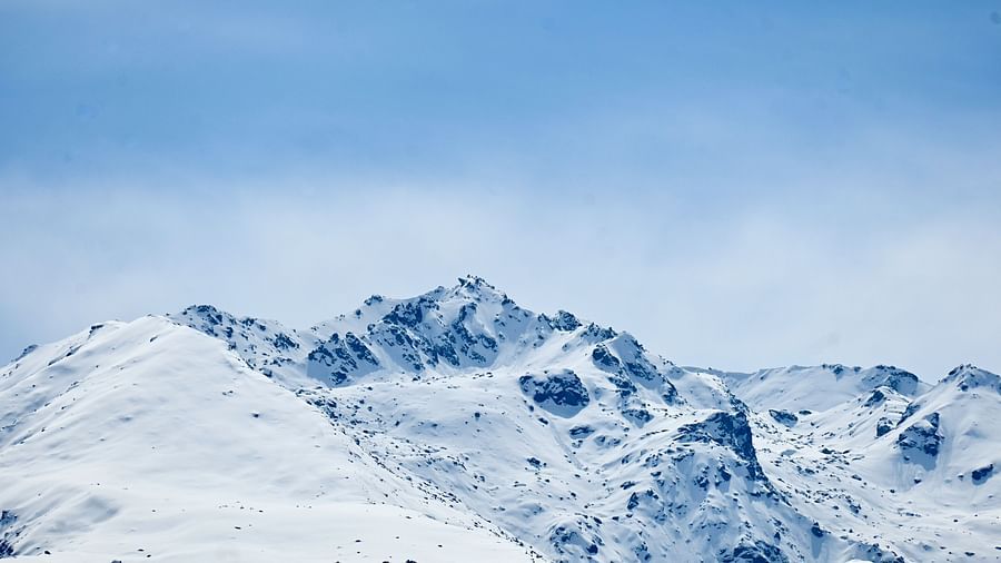 A picture featuring snow capped mountains captured in the day time.