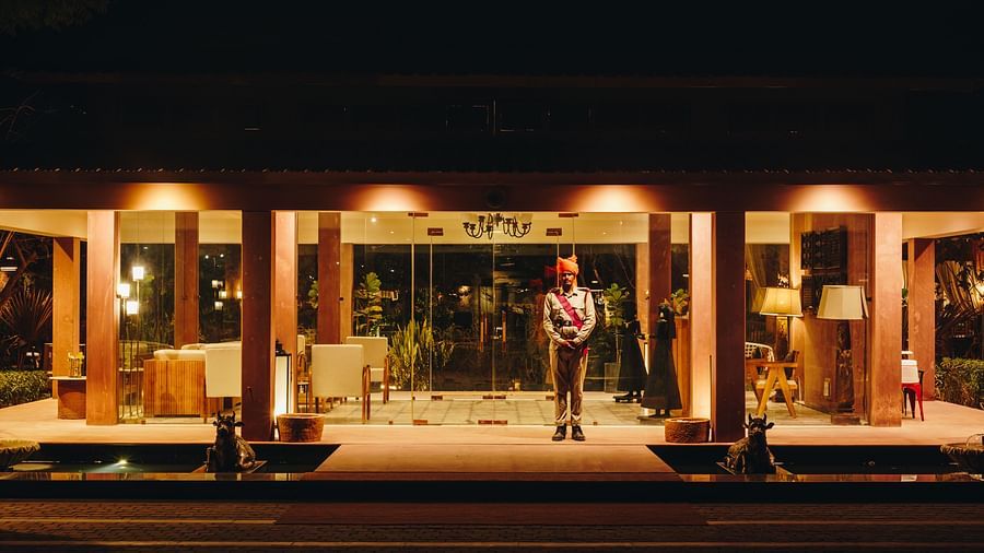 Night view of the recepetion area with a guard standing in front at Surpura Bagh.