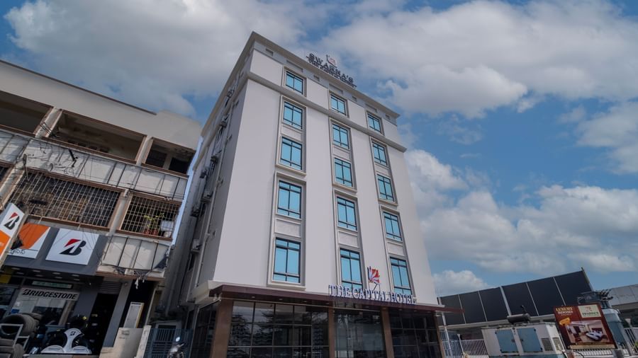 Angled exterior view of Swarna's The Capital highlighting its urban setting and stylish structure.