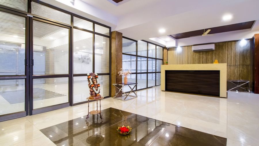 Modern hotel reception area with marble flooring elegant decor and welcoming ambience at Swarna's The Capital.