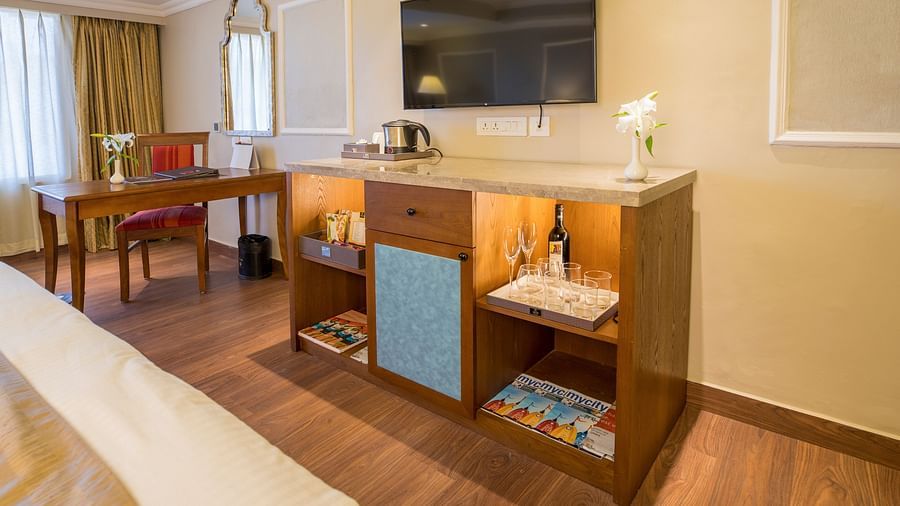 Spacious bed with a wall-mounted TV opposite it 