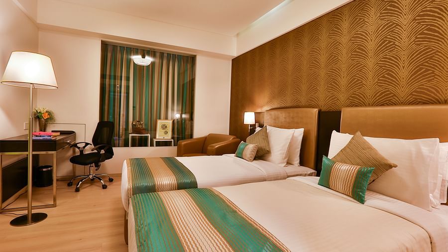 A room with twin beds and a work desk and chair at T24 Residency, Andheri East, Mumbai