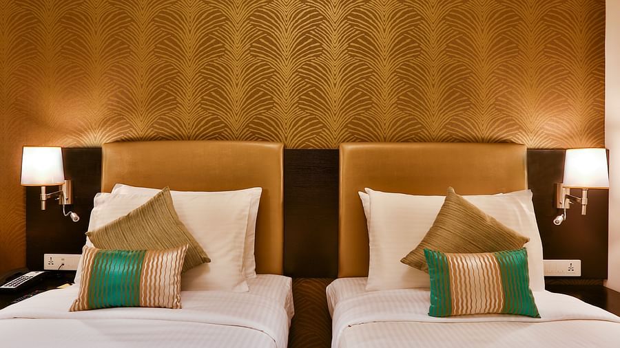 Front view of a room with twin beds and side tables with night lights at T24 Residency, Andheri East, Mumbai