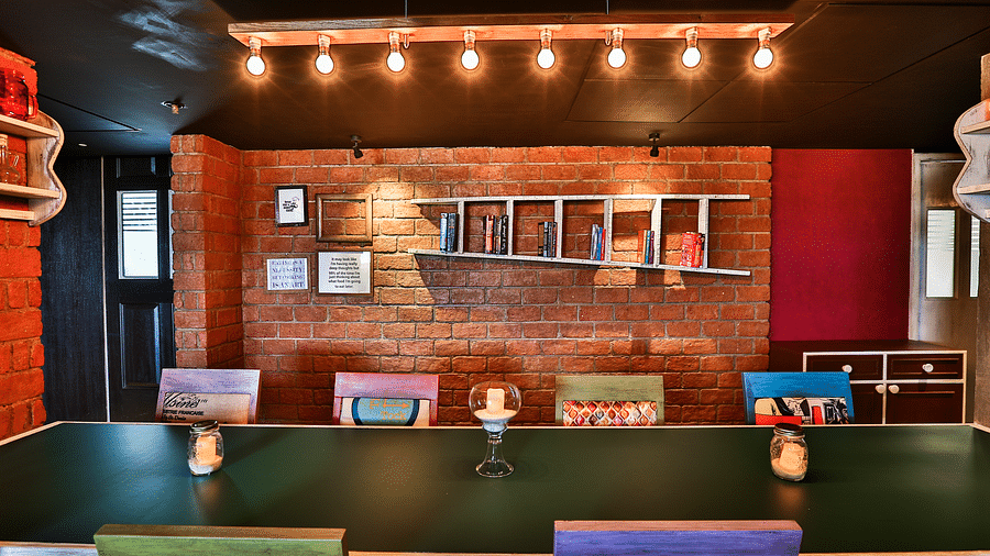 A view of the dining arrangement at T24 Residency, Andheri East, Mumbai with the backdrop of a brick wall