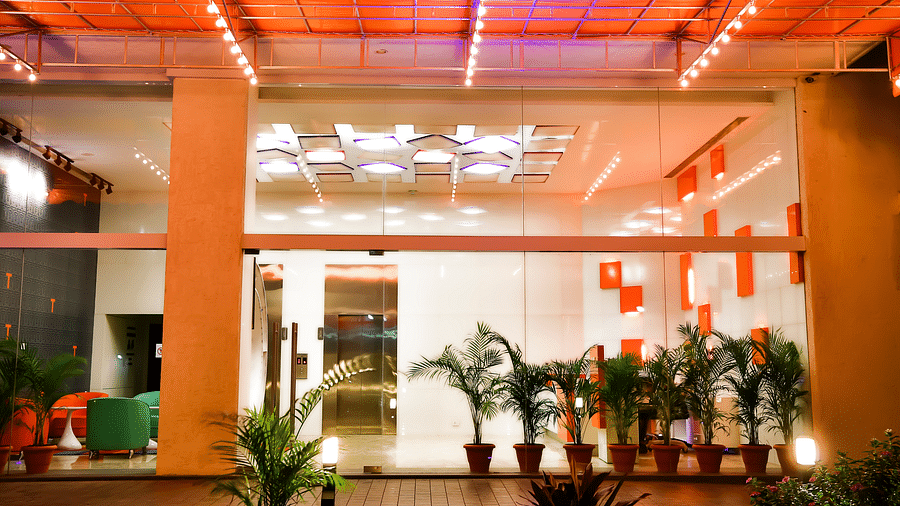 Entrance to T24 Residency, Andheri East, Mumbai with potted plants placed outside the glass doors