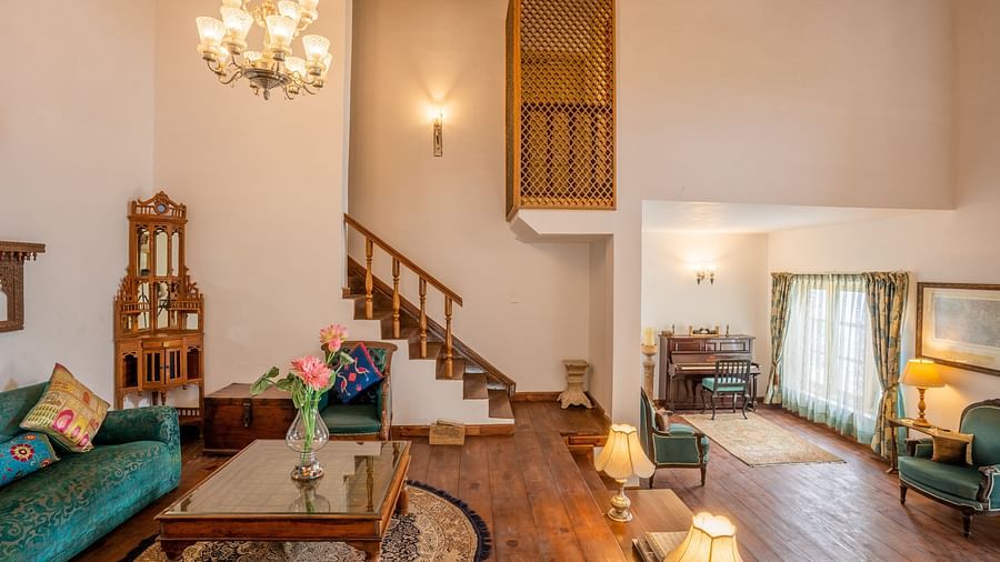 A living room with sofa and table at Te Aroha By Shervani, Mukteshwar