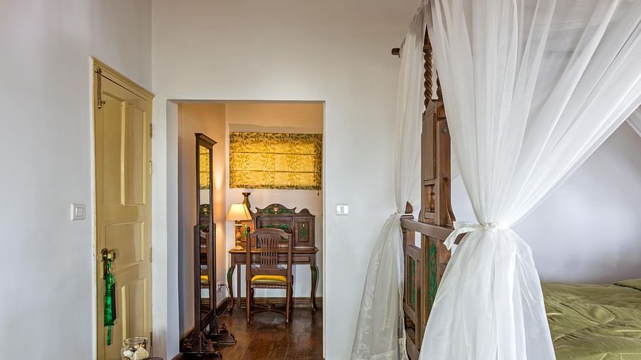 Side view of the 3 BHK room with canopy on the sides on the bed at Te Aroha by Shervani Mukteshwar