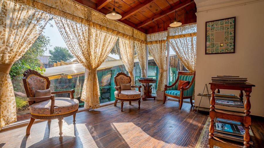 An open area with chairs and curtains at Te Aroha By Shervani, Mukteshwar