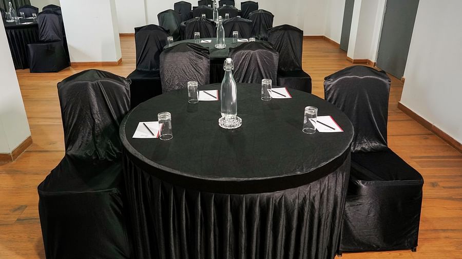 A close view of round tables and chairs covered in black in our conference room - TGI Ameya Grand, Goa