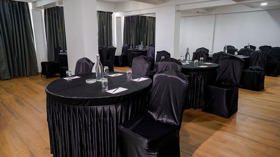 Another view of our spacious conference room with round tables and chairs covered in black - TGI Ameya Grand, Goa