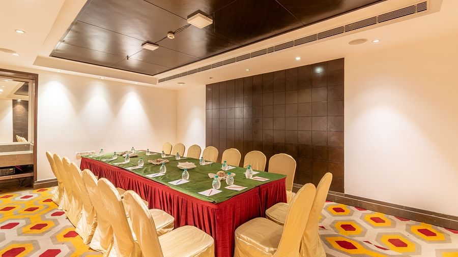 Compact meeting room with U-shaped table arrangement and vibrant carpet flooring- TGI Grand Fortuna, Krishnagiri Main Road, Hosur