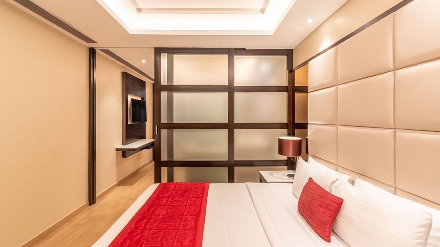 Elegant bedroom of fortuna suite with large bed and stylish decor- TGI Grand Fortuna, Krishnagiri Main Road, Hosur