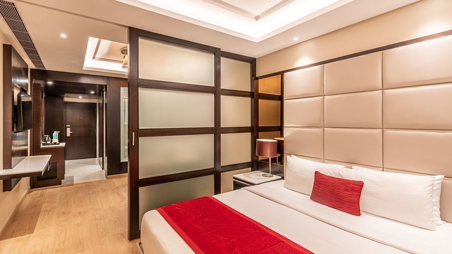 Fortuna suite view showing bed, wardrobe, and seating arrangement- TGI Grand Fortuna, Krishnagiri Main Road, Hosur