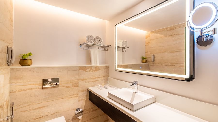 Contemporary bathroom with illuminated mirror and sleek design- TGI Grand Fortuna, Krishnagiri Main Road, Hosur