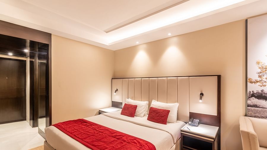 Room view showing twin beds, wardrobe, and side table- TGI Grand Fortuna, Krishnagiri Main Road, Hosur
