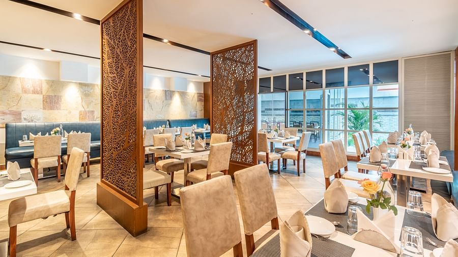 Elegant restaurant layout with decorative partitions and cosy seating- TGI Grand Fortuna, Krishnagiri Main Road, Hosur