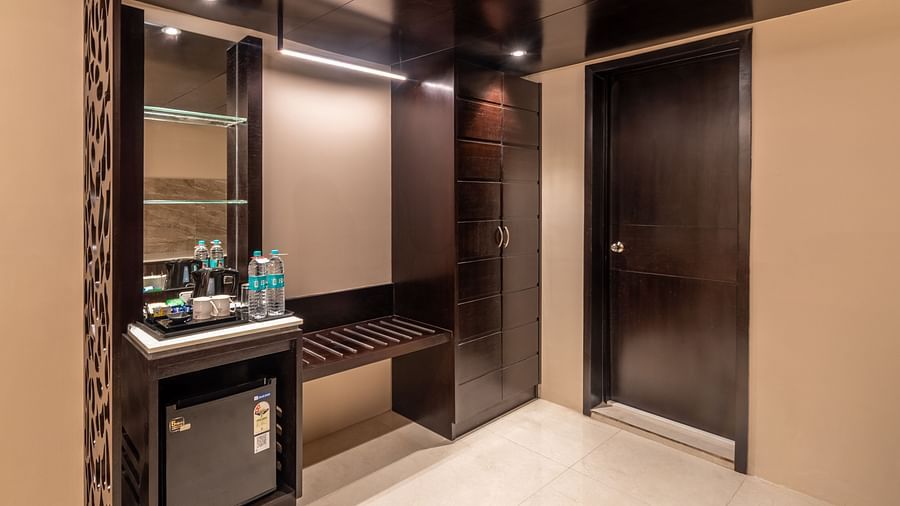 Hallway section of the room with dark wooden panels and a minibar- TGI Grand Fortuna, Krishnagiri Main Road, Hosur