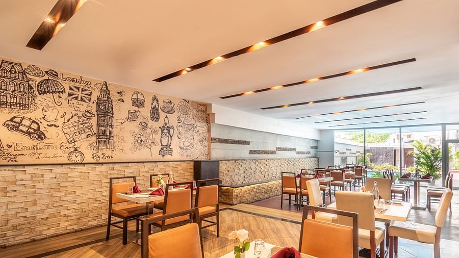 Long dining layout with classic wooden furniture and good ambience- TGI Grand Fortuna, Krishnagiri Main Road, Hosur