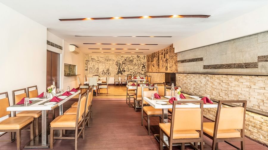 Long dining layout with classic wooden furniture- TGI Grand Fortuna, Krishnagiri Main Road, Hosur