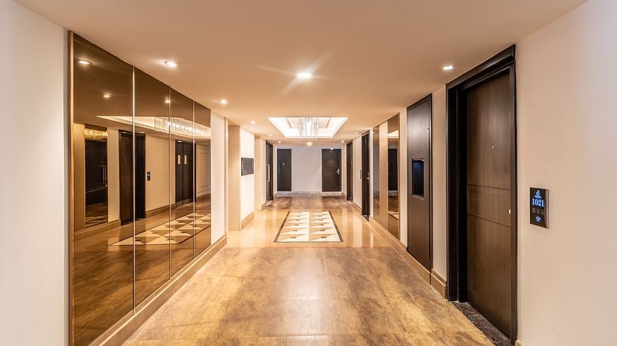 Modern elevator lobby with sleek wooden flooring and ambient lighting- TGI Grand Fortuna, Krishnagiri Main Road, Hosur