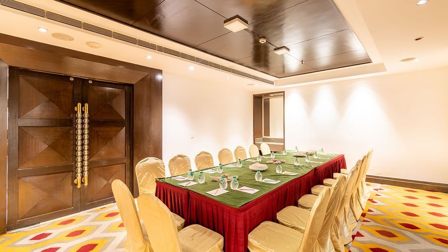 Professional boardroom setup with elegant wood paneling and plush seating- TGI Grand Fortuna, Krishnagiri Main Road, Hosur