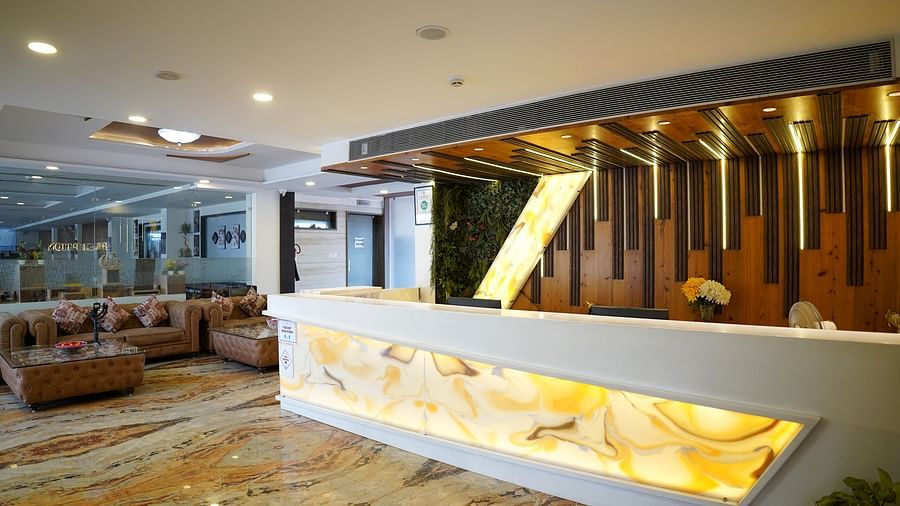 A spacious hotel lobby with modern decor and a reception desk - TGI Insignia, Bhopal