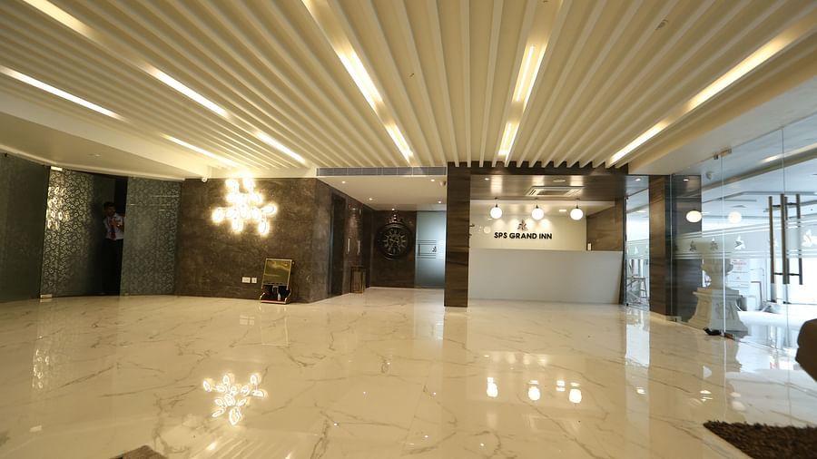 An expansive lobby or reception area featuring contemporary lighting and a polished floor - TGI SPS Grand, Coimbatore