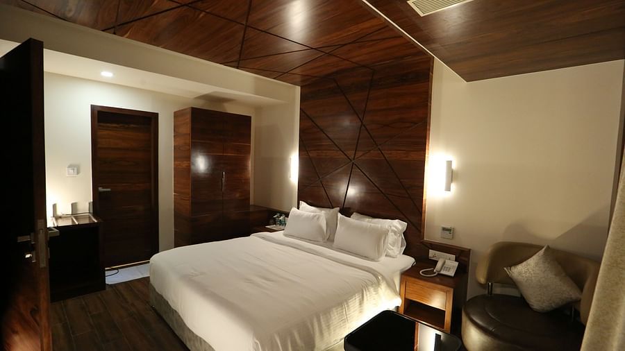 Premium Suite featuring a king size bed and bedside tables. - TGI SPS Grand, Coimbatore