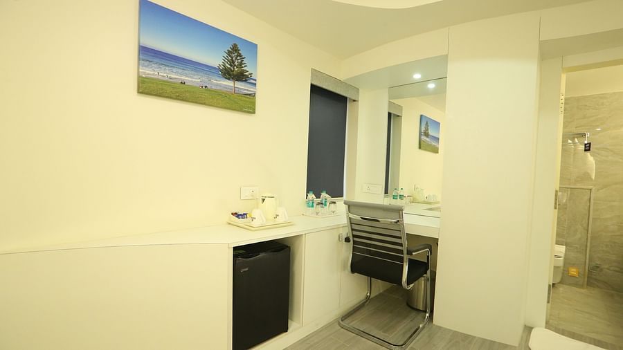 A wider view of Club Suite, highlighting the study table near the washroom - TGI SPS Grand, Coimbatore