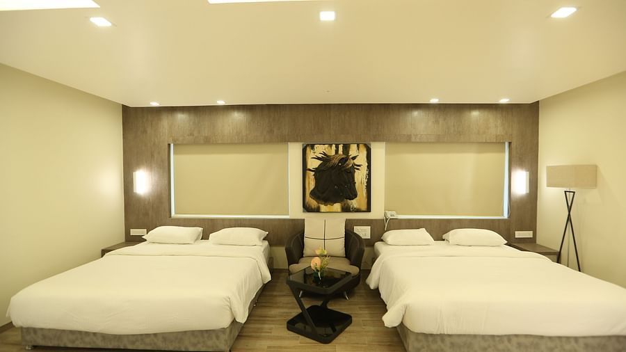 Club Suite with two double beds, and soft lighting.