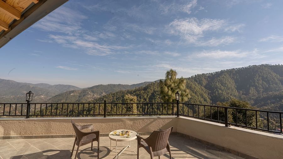 Spacious balcony with outdoor furniture and a mountain view at The Chamomile Estate.