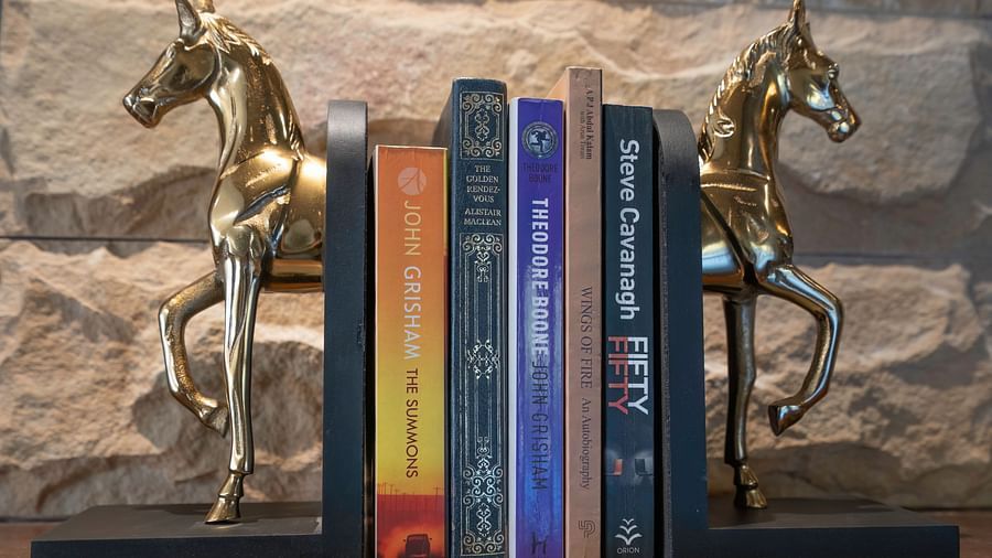 Decorative bookends shaped like horses, holding a bunch of books at The Chamomile Estate.
