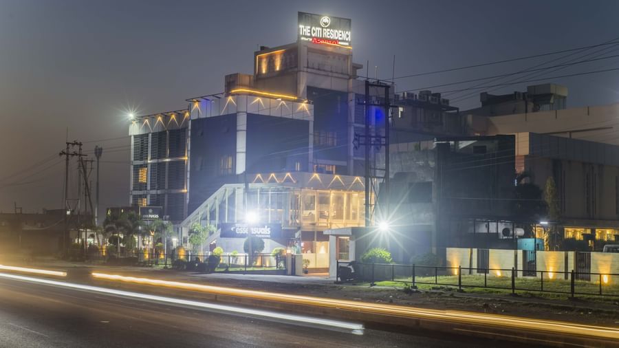 The Citi Residence Hotel, Asansol, illuminated at night with light trails from passing vehicles.