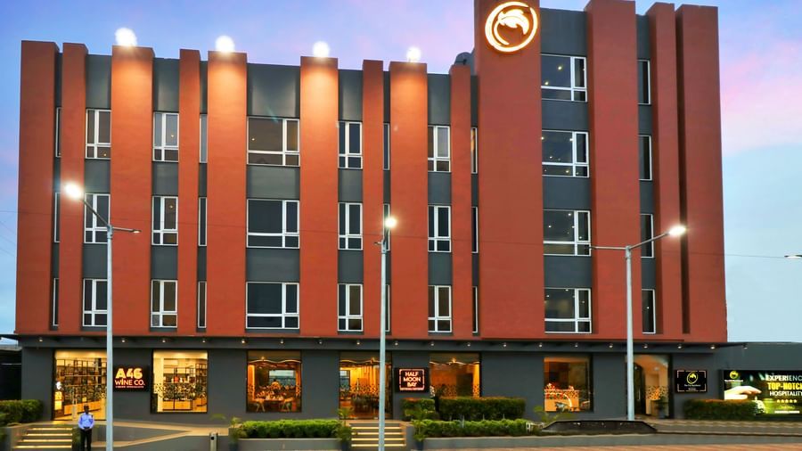 A hotel building with orange and grey facade illuminated at dusk | The Citi Residenci Hotel Banskopa